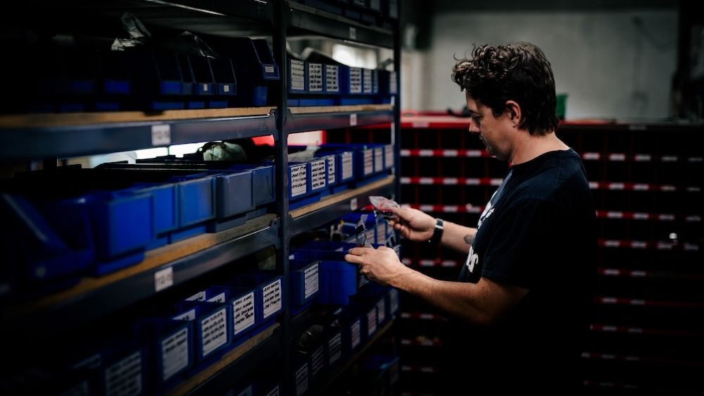 Mach 6 technician working with digital records at the parts bins