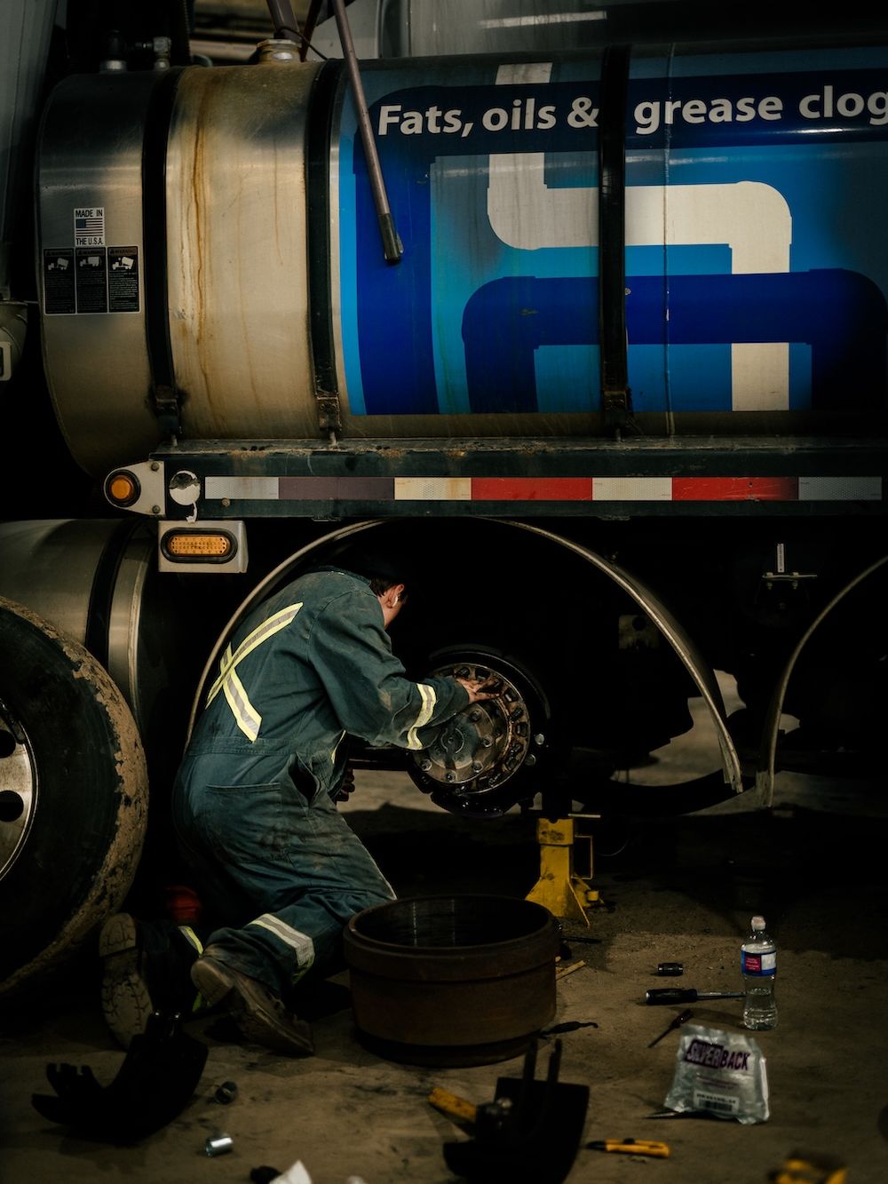 Technician working underneath a commercial trailer at Mach 6