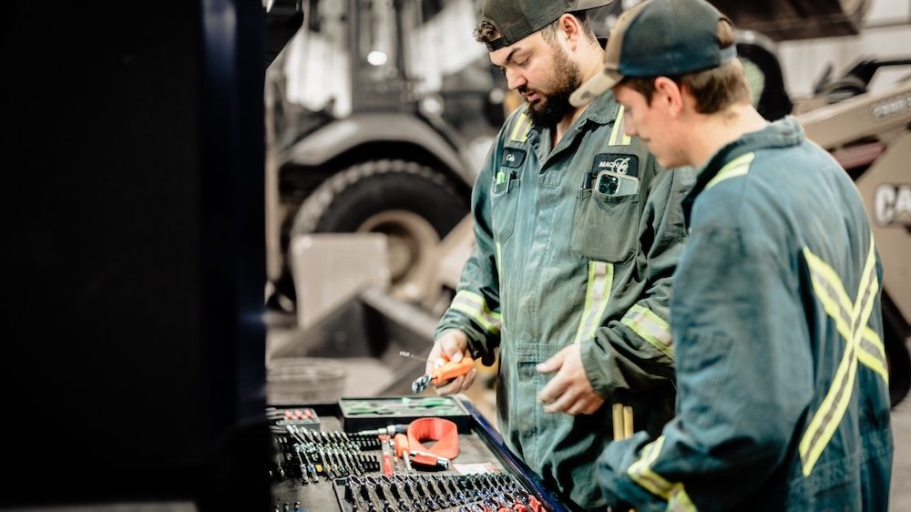 Mach 6 technicians at the diagnostic tool chest in the shop